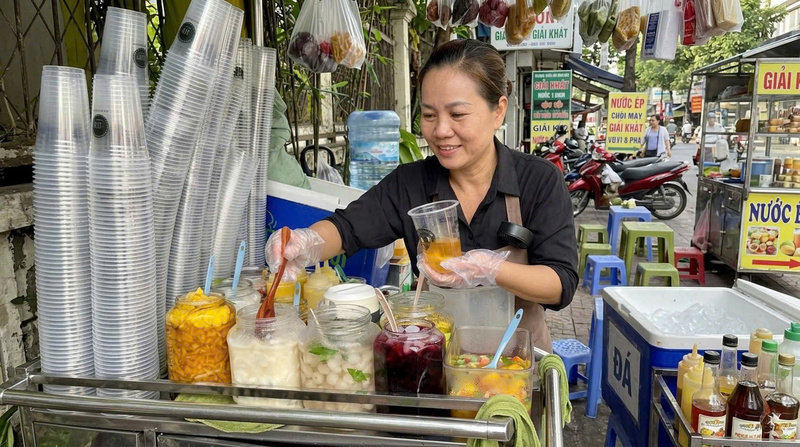 Quầy nước nhỏ của chị Hương luôn sẵn sàng phục vụ khách trong những ngày nắng nóng từ trà, nước ép trái cây đến các món trái cây ngâm. Ảnh: Minh Anh